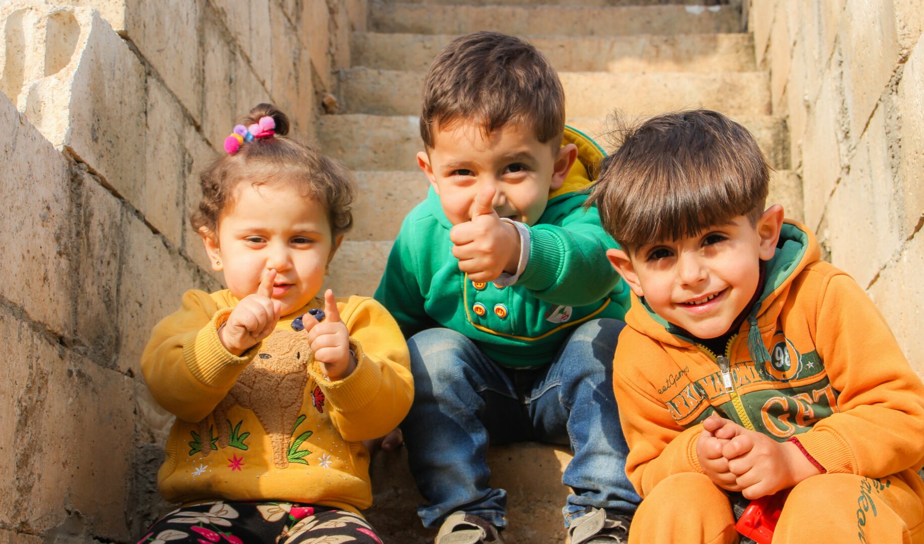 three-children-sitting-on-stairs-1212805